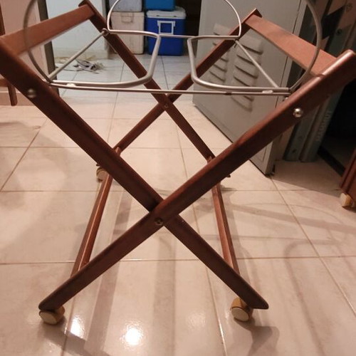 Baby bassinet used with wooden base and beige mattress
