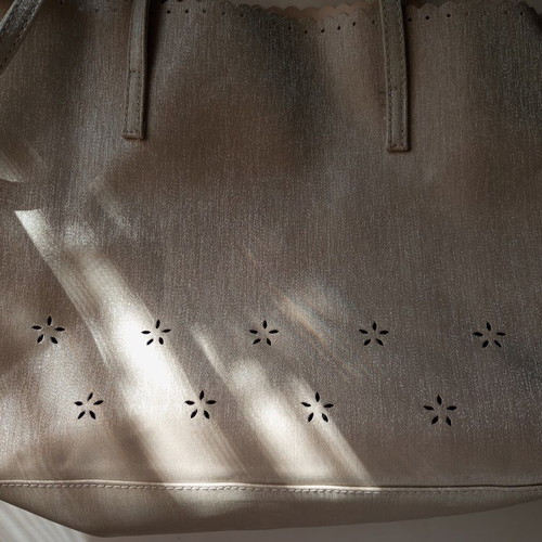Women's shoulder bag metallic silver with flower cutouts