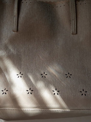 Women's shoulder bag metallic silver with flower cutouts