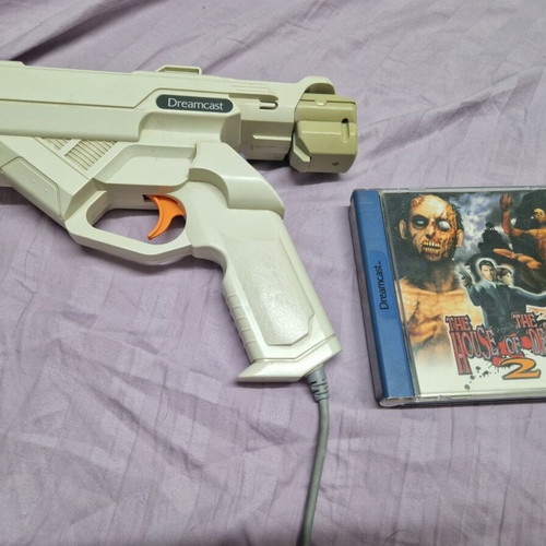 Sega Dreamcast console used with 2 games, 2 controllers, memory cards, light gun, rumble pack