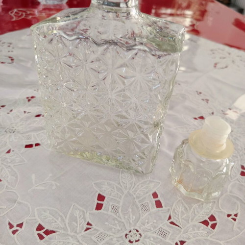 Vintage glass decanter with embossed geometric design and stopper