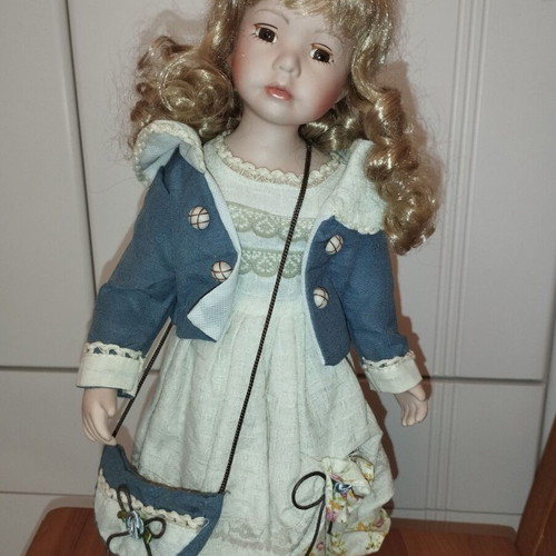 Porcelain doll rare, new with hat and dress