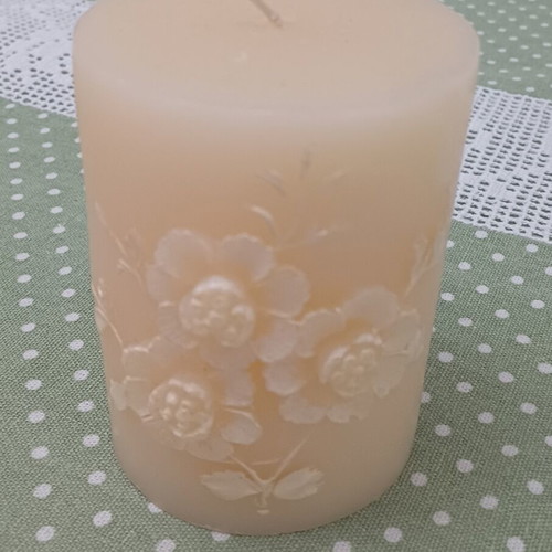 Decorative candle with embossed floral design like new, cream color