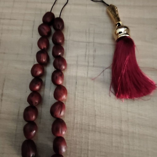 Handmade komboloi with 21 nutmeg beads, tassel and gold-plated shield