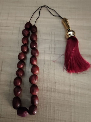 Handmade komboloi with 21 nutmeg beads, tassel and gold-plated shield