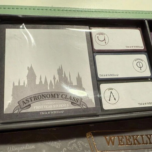 Harry Potter stationery set with pen, weekly planners, post-its, and lightning bolt clips