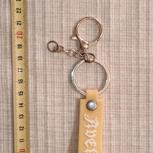 Avengers keychain like new, white and yellow