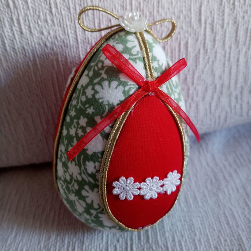 Decorative egg used red and pistachio with daisies