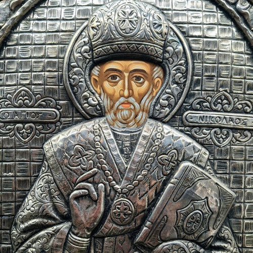 Silver embossed icon of Saint Nicholas used, with wooden base