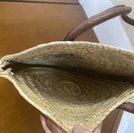 Round woven straw shoulder bag with leather handles
