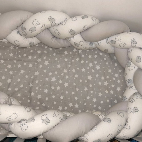 Baby braided crib bumper used in gray and white