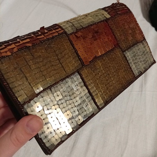 Official hand bag like new in brown shades with sequins