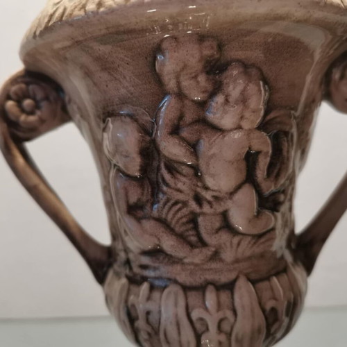 Faience amphora used with embossed design and cupids