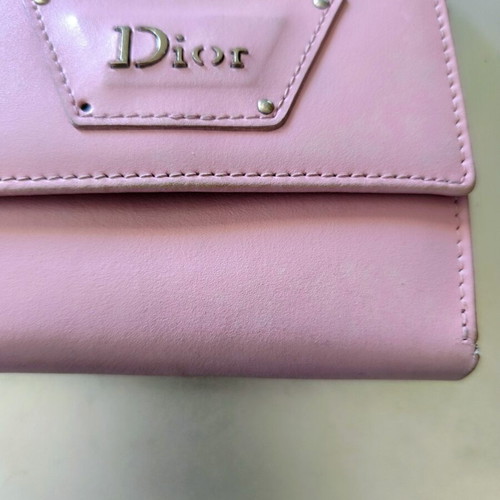 Dior wallet used, pink with slight wear and missing stud