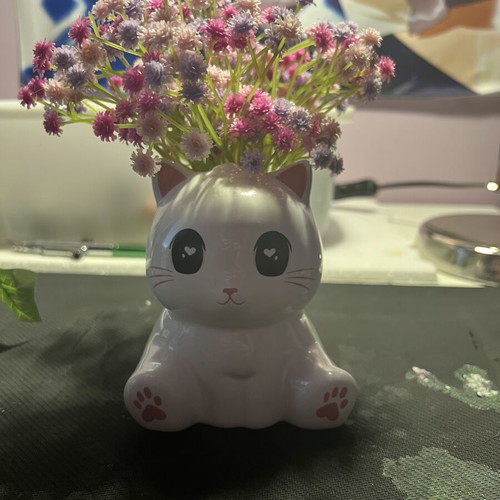 Decorative clay cat with flowers