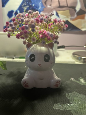 Decorative clay cat with flowers