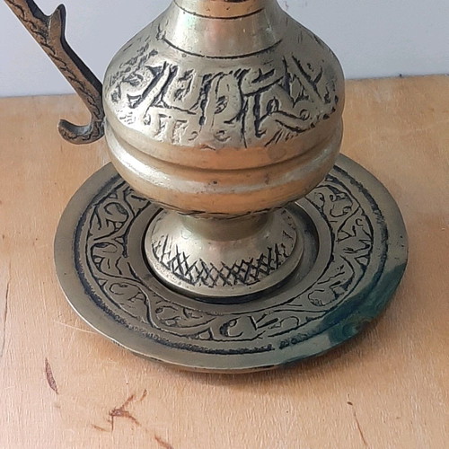 Oriental solid brass pitcher used with saucer