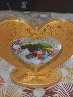 Golden heart of porcelain and liquid glass with photo