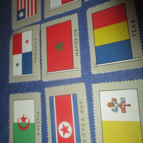 Lot of 36 used country flag stickers, 1960s collection
