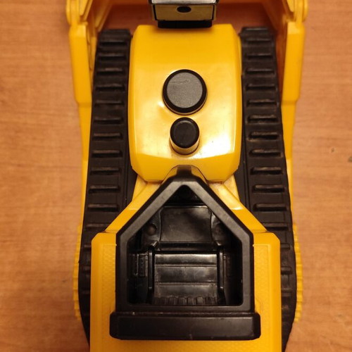 CAT bulldozer toy used with moving tracks and gradual forward-back motion