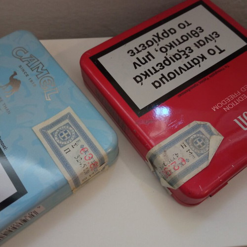 Camel and Winston collectible metal cigarette packs