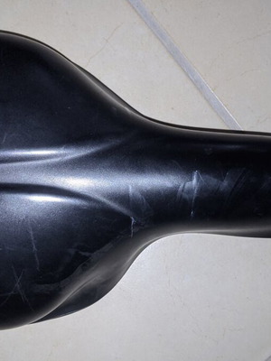Comfortable black bicycle saddle with mounting clamp