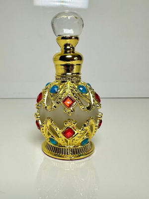 Vintage Arabic perfume bottle with gold metal frame and stones
