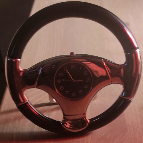 Clock shaped like a steering wheel with stand like new