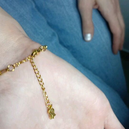 Gold steel chain bracelet with charm