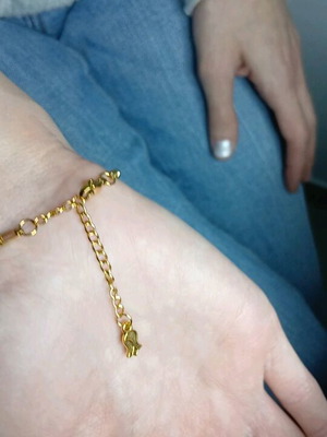 Gold steel chain bracelet with charm