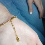 Gold steel chain bracelet with charm