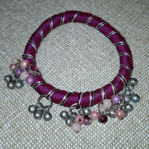 Fabric bracelet used, purple with bells