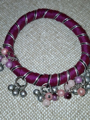 Fabric bracelet used, purple with bells
