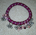 Fabric bracelet used, purple with bells