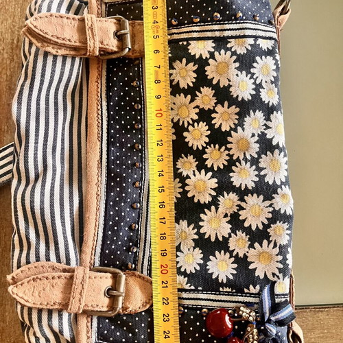 Accessorize vintage crossbody bag with daisies and cherries