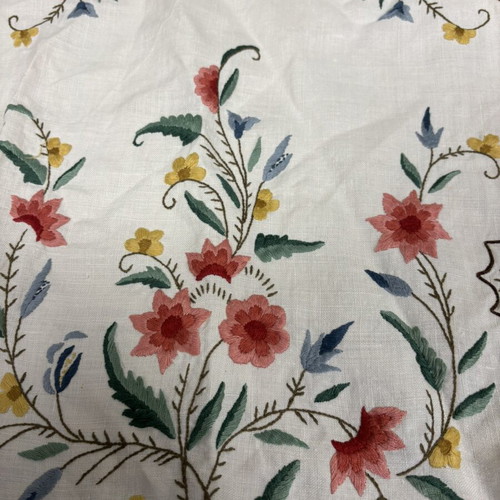 White embroidered table runner and napkin set used with colorful flowers