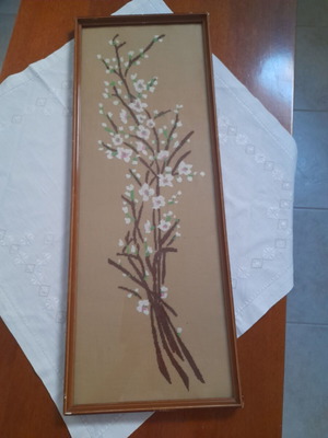 Vintage frame with handmade embroidery of blossoming almond branches, used