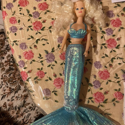 Mermaid doll with clothes used, damaged doll and worn clothes