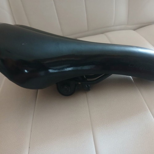 Carrera bicycle saddle like new with integrated rail clamp black