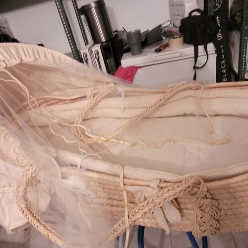 Baby bassinet used with wooden base and beige mattress