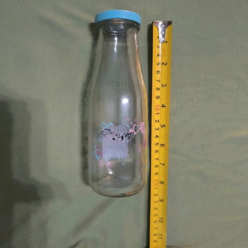Glass water bottle used with hole for straw