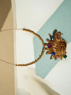 Handmade necklace with gold beads and peacock pendant