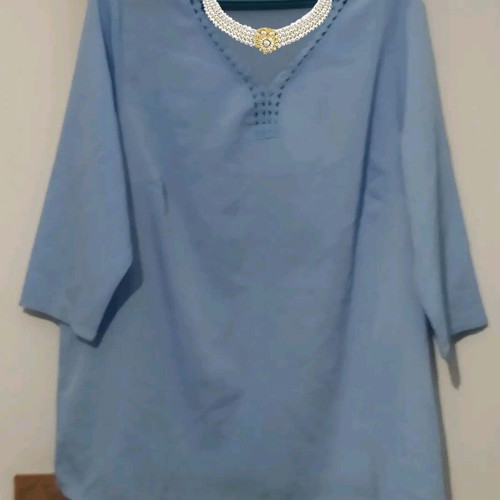 Light blue blouse with decorative neckline