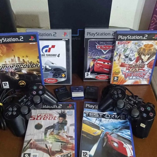 PlayStation 2 used with 7 games, 3 memory cards, 2 controllers and steering wheel pack