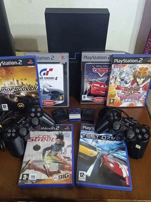 PlayStation 2 used with 7 games, 3 memory cards, 2 controllers and steering wheel pack