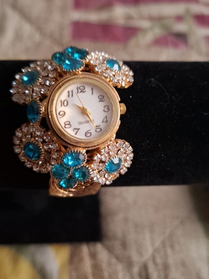 Wristwatch new, gold pink with blue zircon