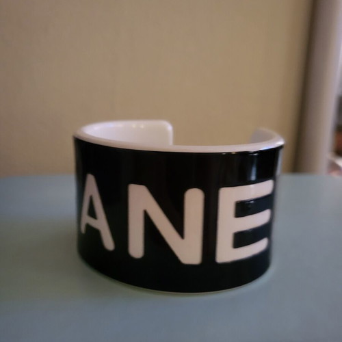 Cuff bracelet like new, black resin with white letters