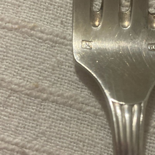 Vintage silver-plated food fork used with embossed decoration