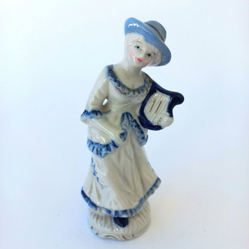 Porcelain figurine with girl musician like new