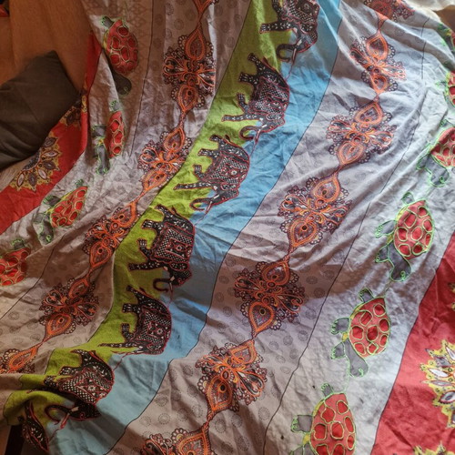 Throw from India used with hand-stitched colorful animal motifs